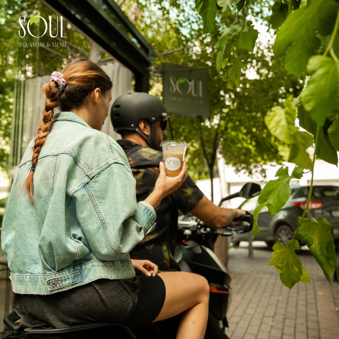 a woman and a guy taking a smoothie away